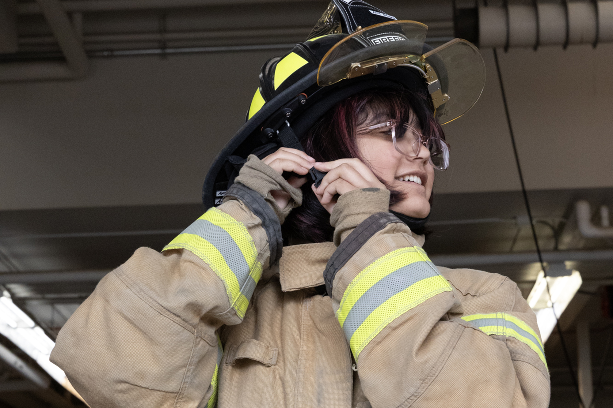 summer camp student puts on a fire helmet