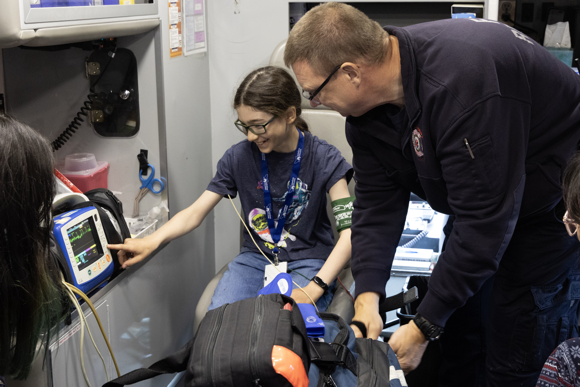 Summer camp student looks at a blood pressure monitor