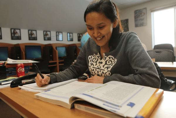 Christina smiles as she works on homework.