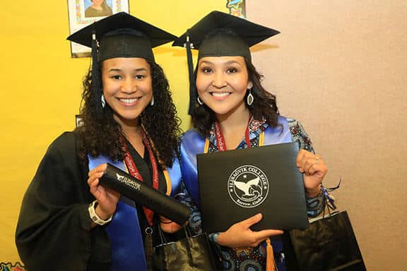 Two students graduating from Iḷisaġvik College