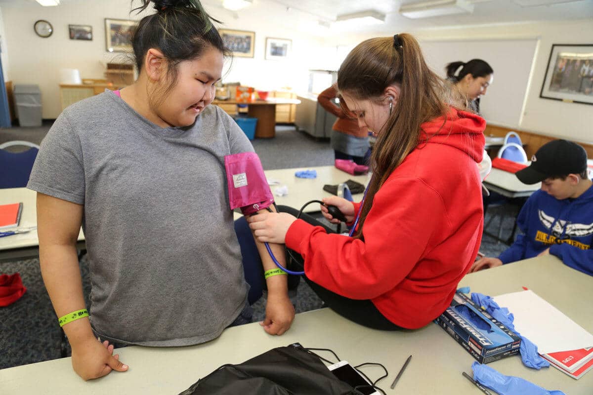 Students practicing blood pressure monitoring.