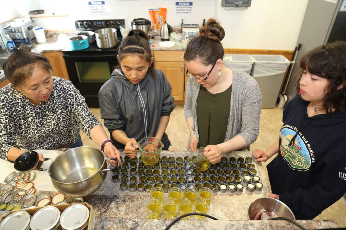 Students learning how to can food.