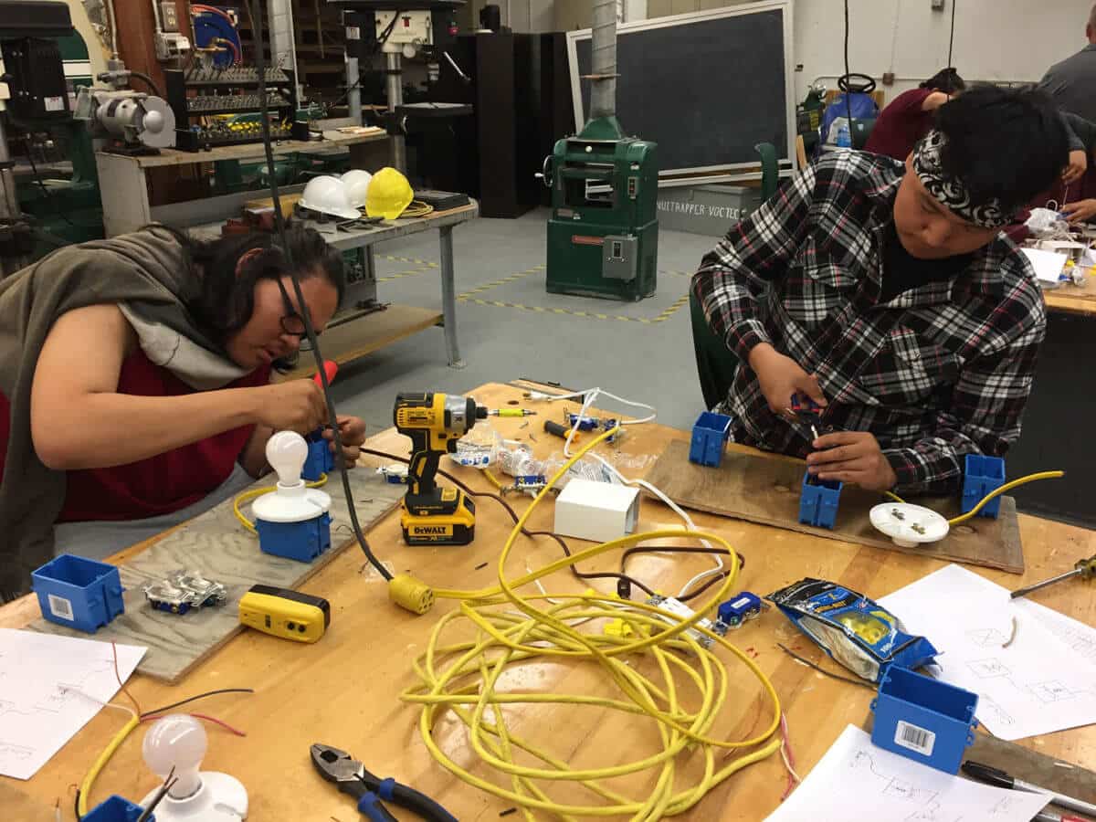 Students learning how to install light fixtures.