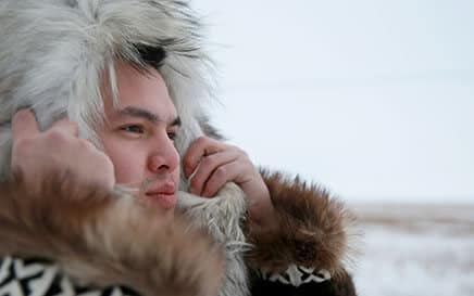 Alaska Native man in traditional fur parka.