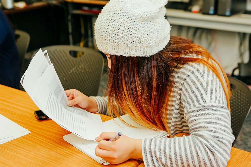 student working on a paper